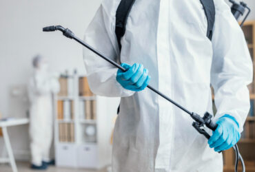 persondisinfectingdangerousareawhilewearingprotectivesuit_1670409647_1670837733